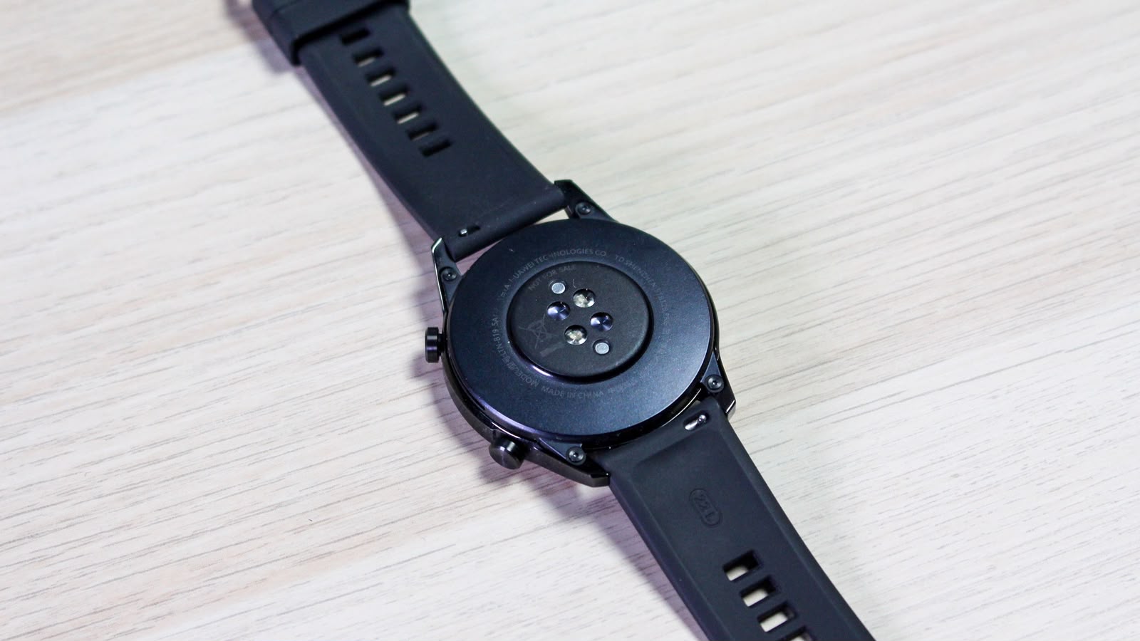 Press the release button on the back of the steel strap